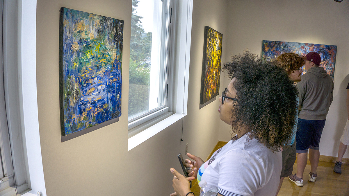 Student looking at artwork.