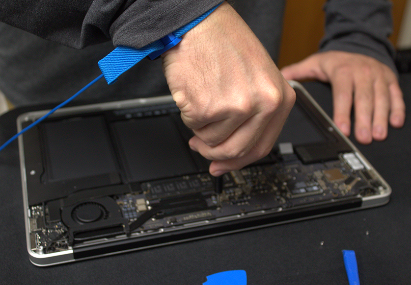 hand working on inside of laptop