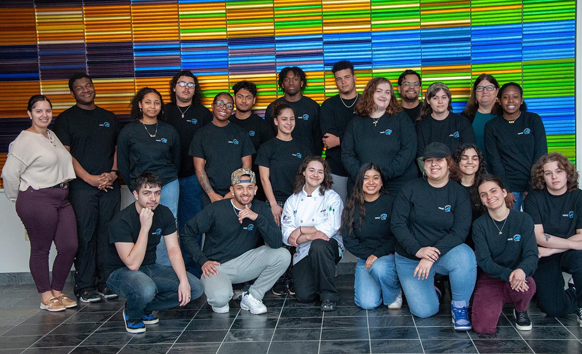 group of students pose and smile at camera