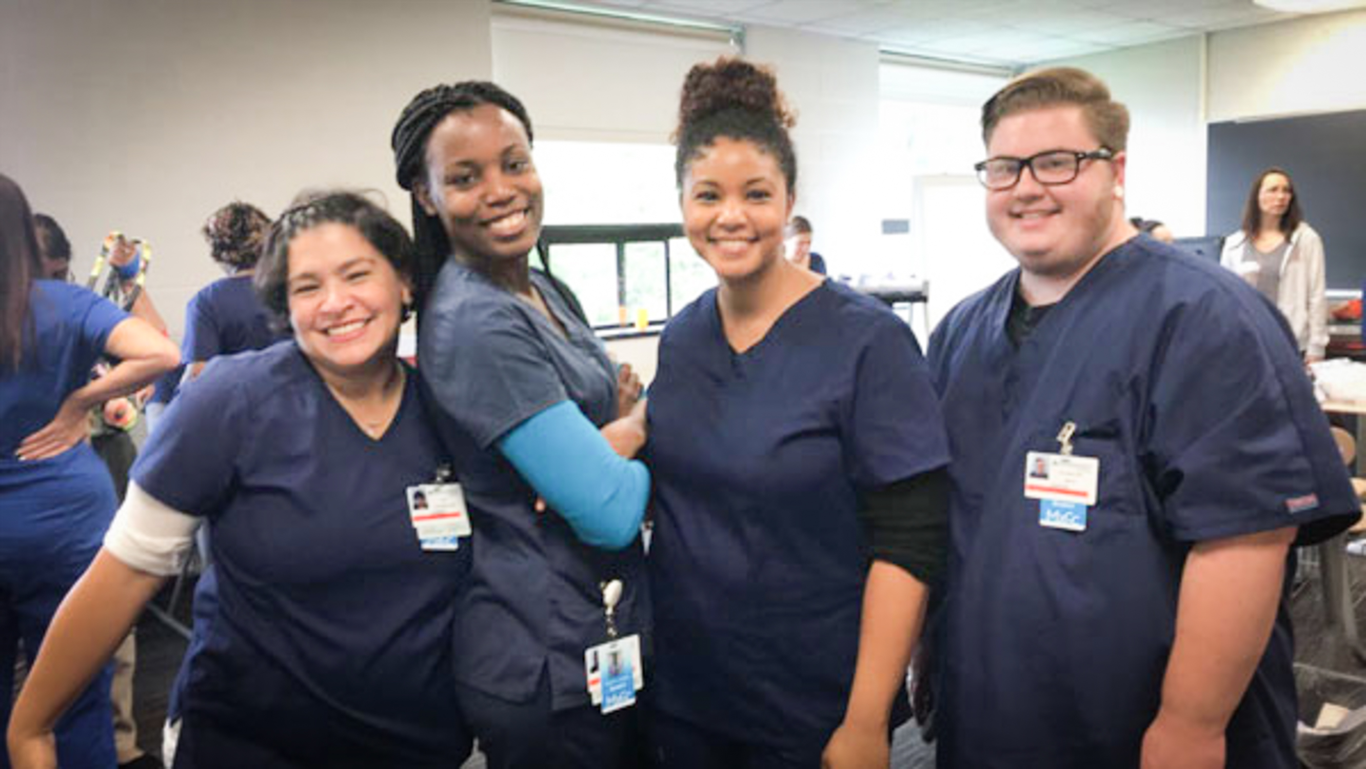 group of phlebotomy students smile for camera