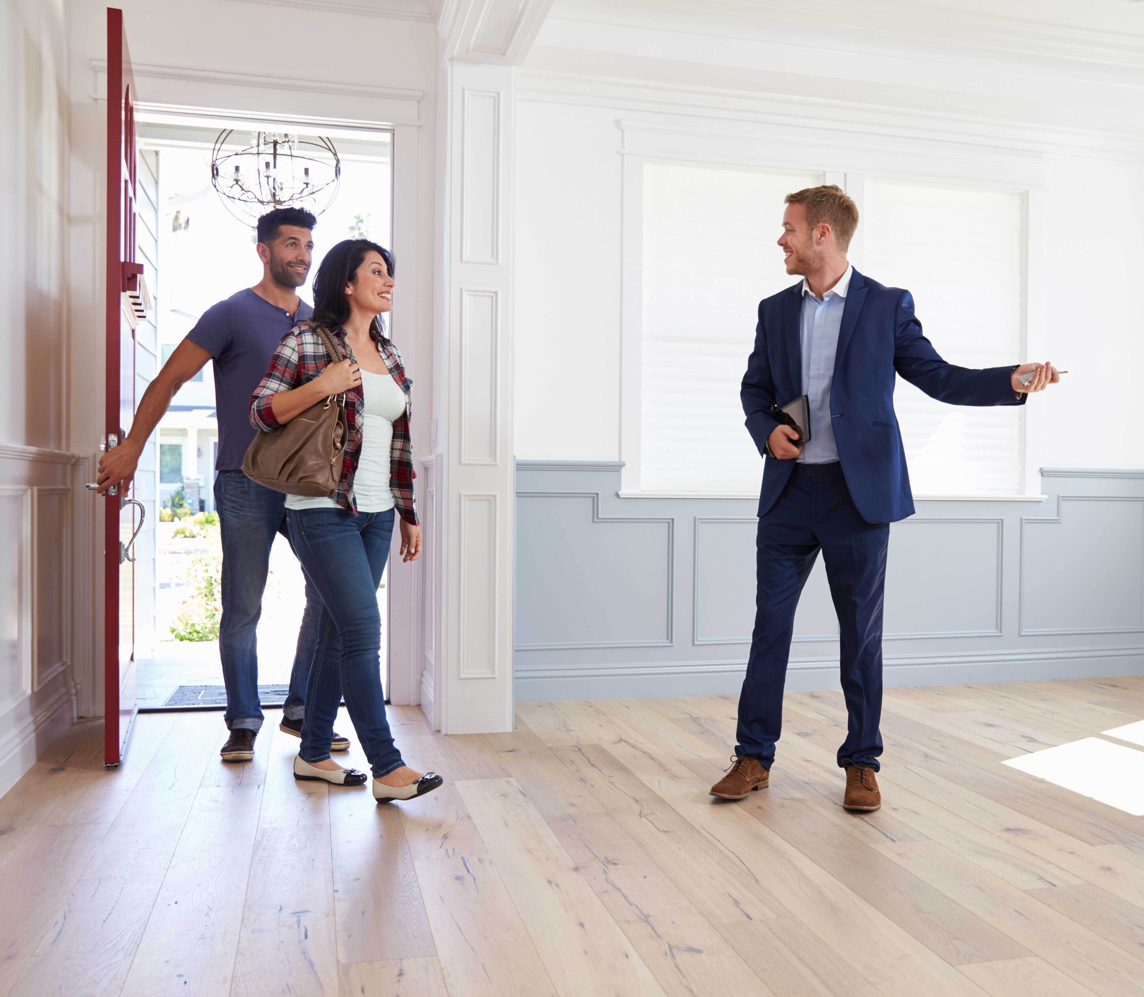 realtor shows entry of house to clients